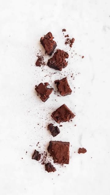 Brownie bites scattered on white marble